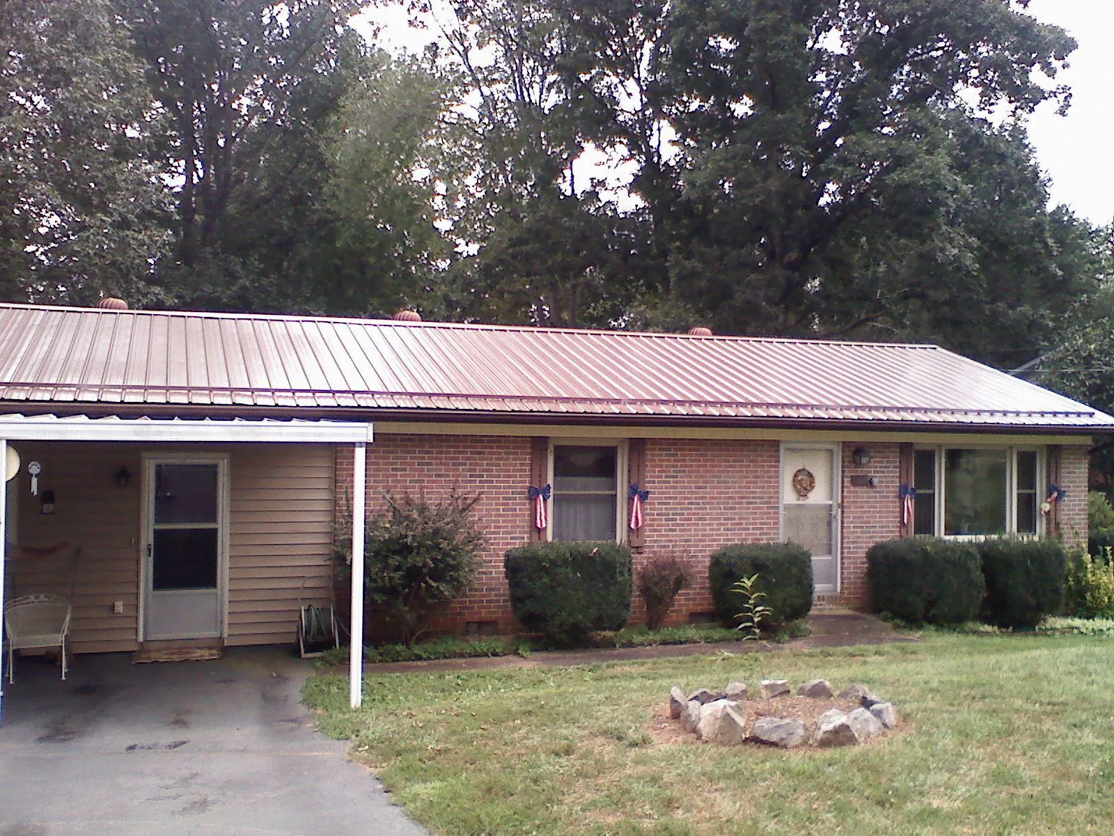 Bronze metal roof and carport on a brick ranch home — Roof Repair work by our crew in Oak Park